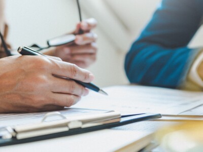 Two people discussing financial documents