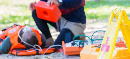 paramedic helping an injured person on the street