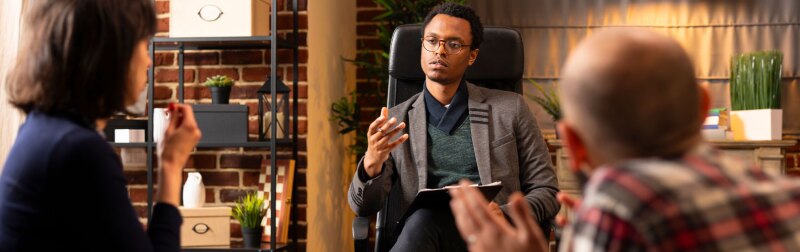 Professional counselor advising couple in therapy.