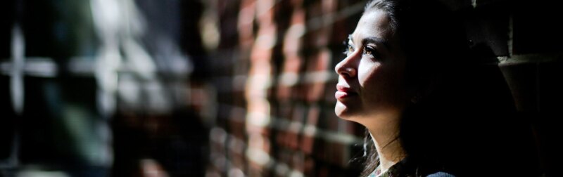 Potential female student contemplates attending college after an open house.