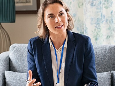 Social worker talking to senior couple at a nursing home