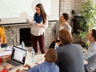 Woman-presenting-to-team