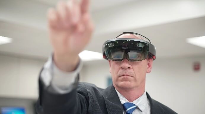 Man in suit using virtual reality helmet