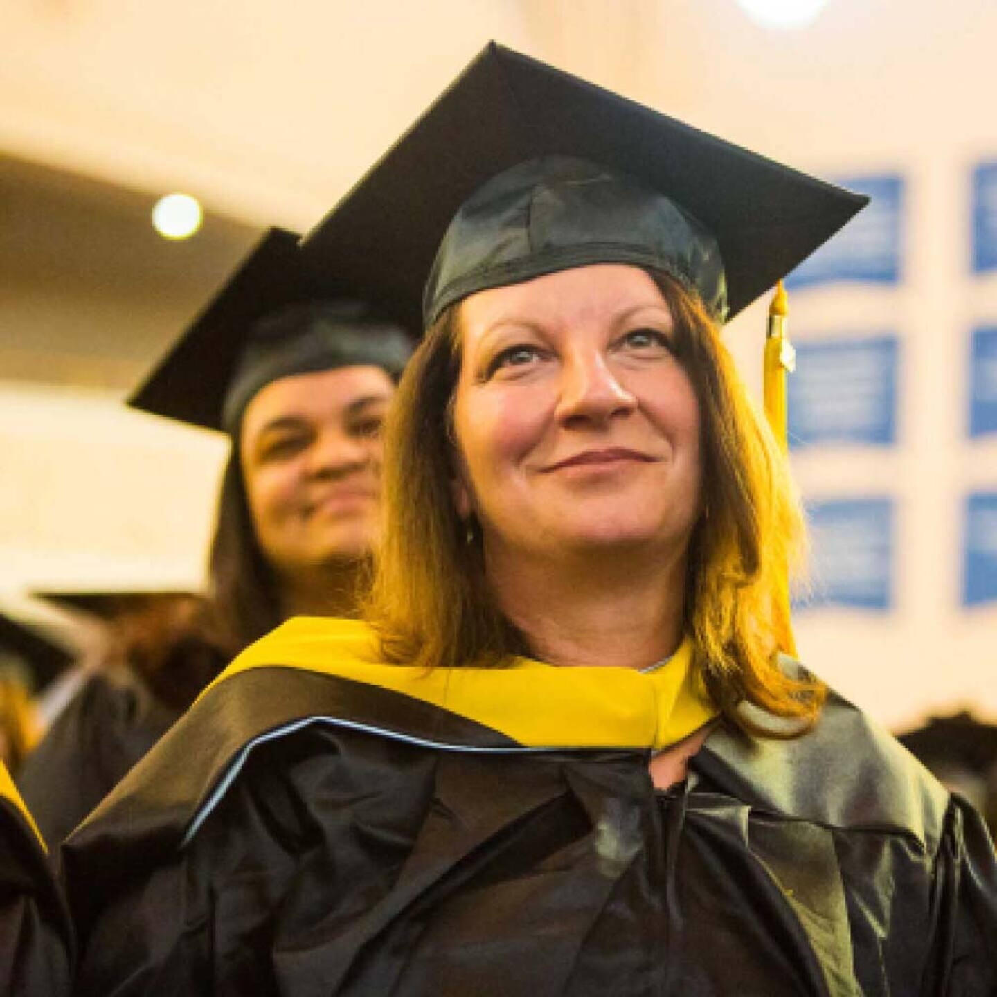 A close-up of a female Yeshiva University graduate during her graduation ceremony.