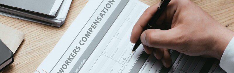 Man filling out a worker's compensation form