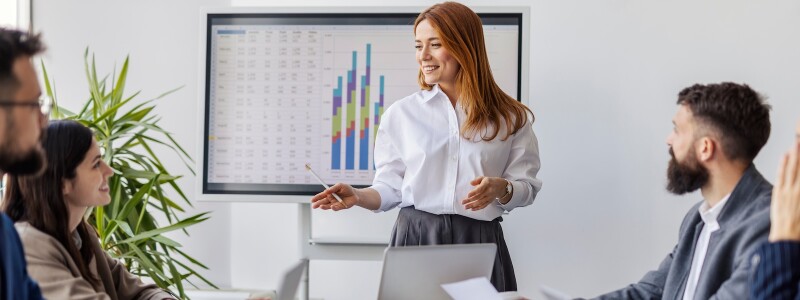 Business analyst presenting data to a meeting of colleagues