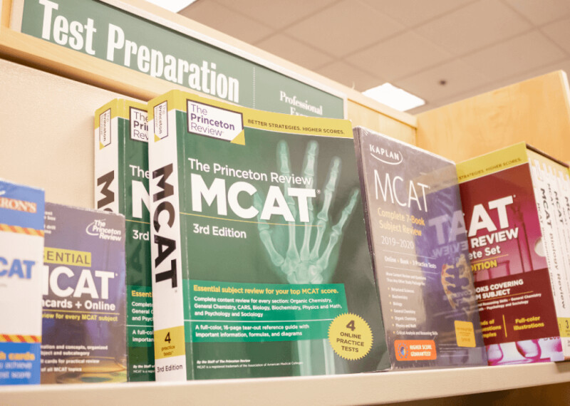 MCAT study workbooks on a shelf in a bookstore