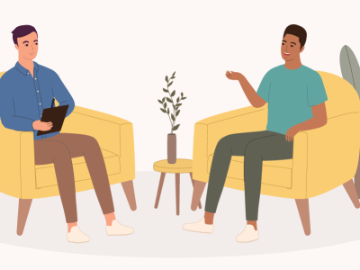 Smiling Black Male Client Talking To His Psychologist Who Is Listening While Taking Notes During The Consultation Session