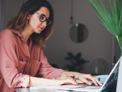 Young focused woman on laptop
