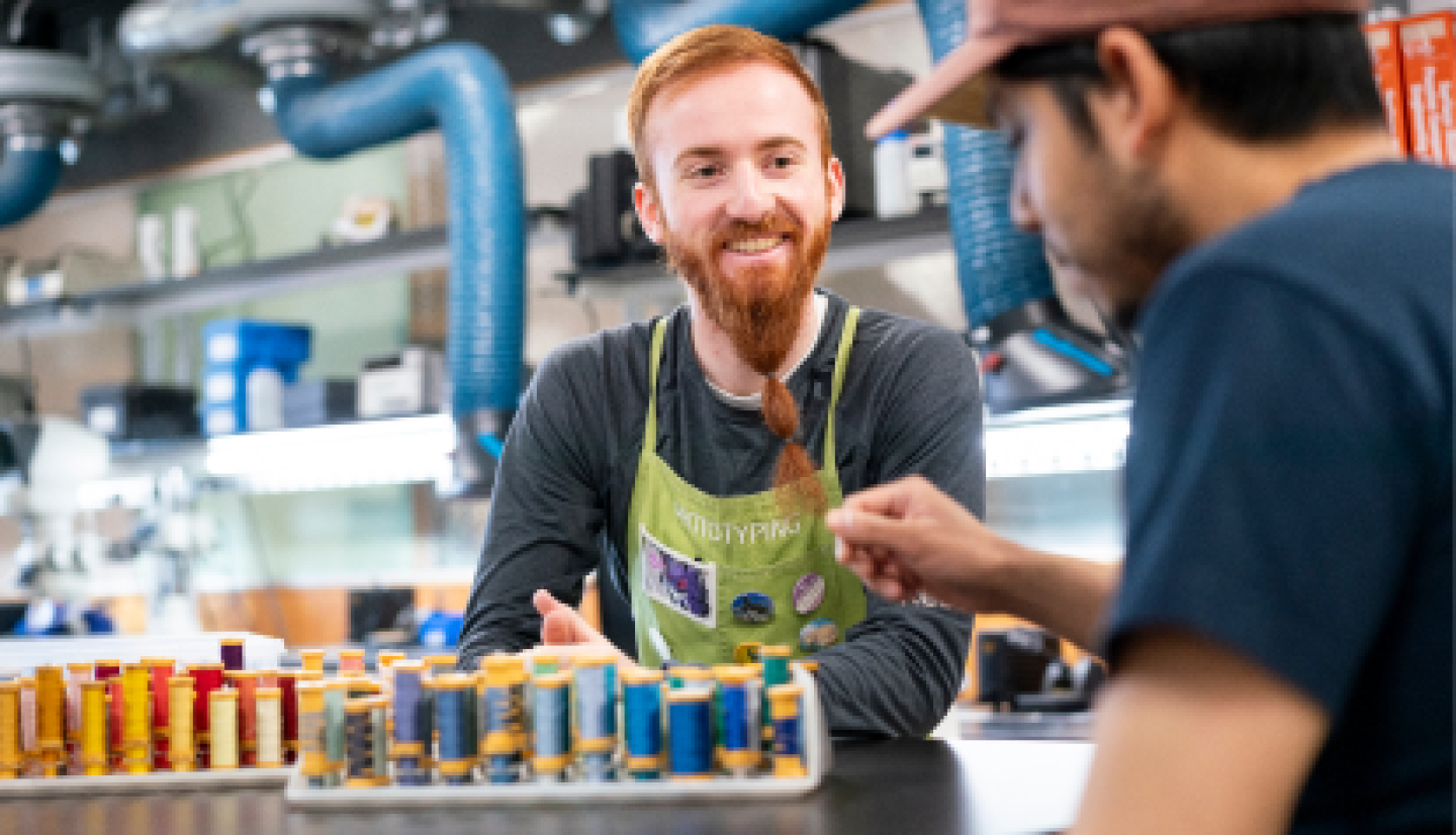 A male CWRU student discussing sample results with a male colleague.