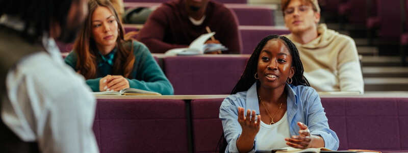 University student asking question during class in lecture hall