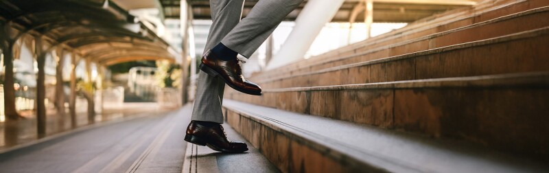 Businessman walking up steps outside in the city