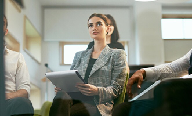 Woman-Taking-Notes-in-Meeting