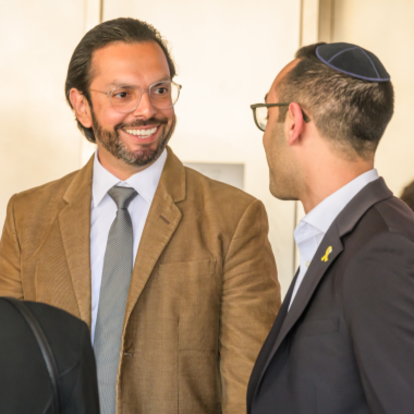 Two male Yeshiva University professors are talking.
