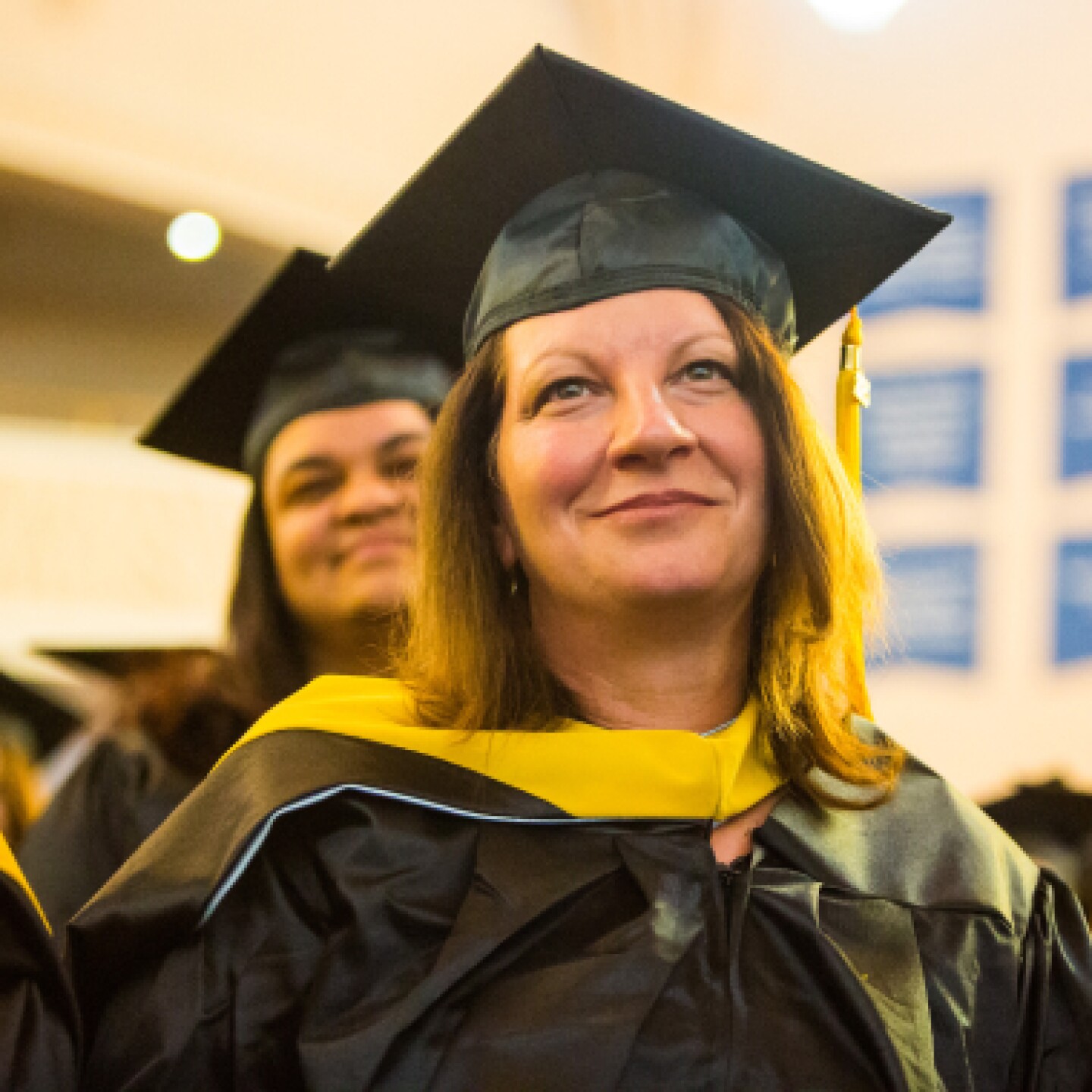 A close-up of a female Yeshiva University graduate during her graduation ceremony.