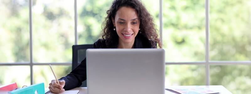 Woman studying on her laptop in her home office
