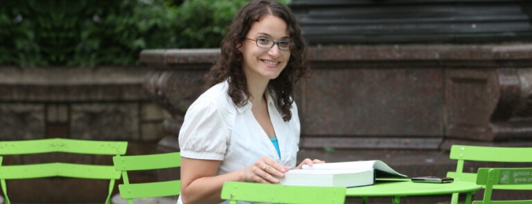 Student works at a table in NYC park