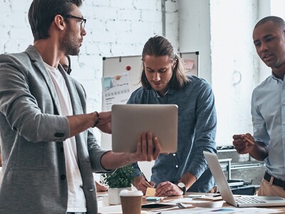 Team of four marketing professionals collaborating in a office on a strategic plan