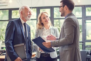 Business professional conversing with peers at a conference event.