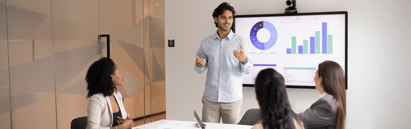 Male analytics professional presenting data to teammates