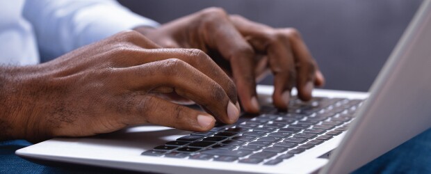 hands typing on a keyboard