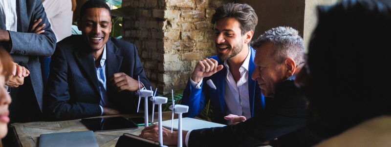 group around table looking at prototype of wind energy
