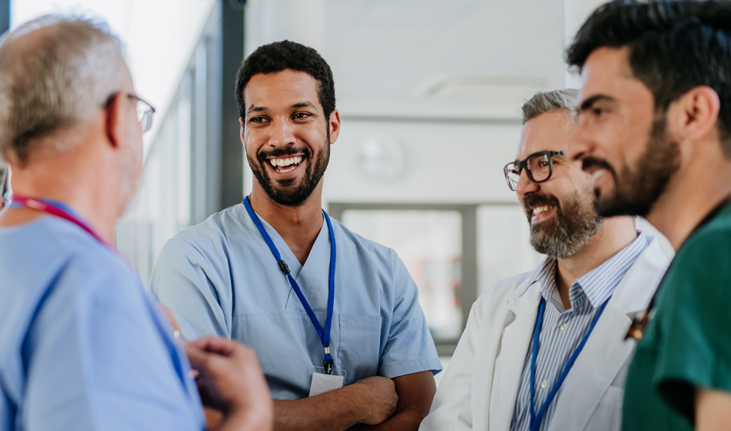 Group of Doctors huddled in an enjoyable conversation