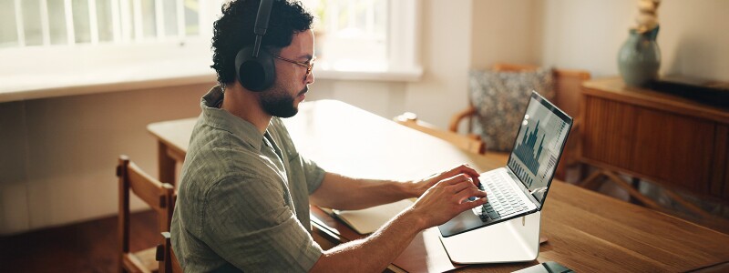 Man at home reviewing an analytics dashboard on his laptop