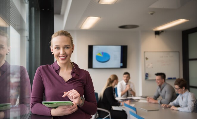 blonde business woman working on tablet at office