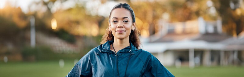Confident female soccer manager on the field