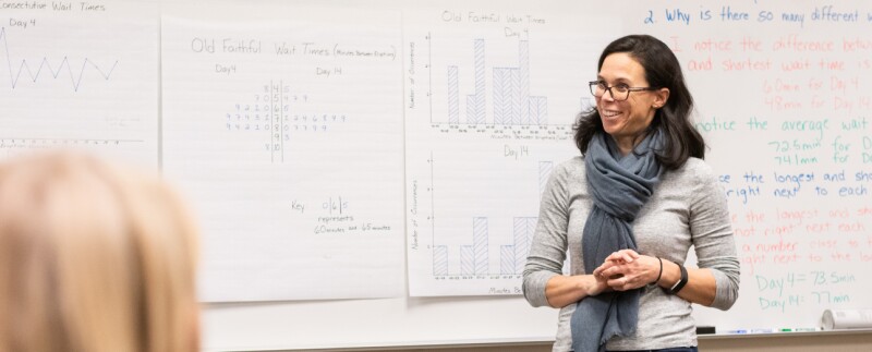 Marquette professor teaching class in front of a whiteboard