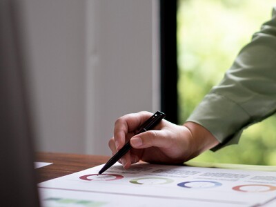 Female accountant reading documents and writing notes
