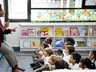 Female teacher talking to elementary students
