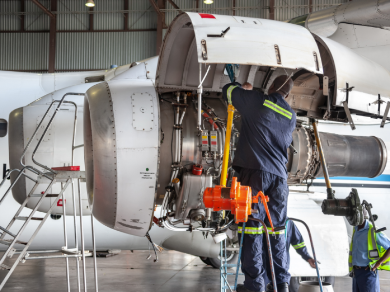 Aerospace engineers configuring a jet engine.