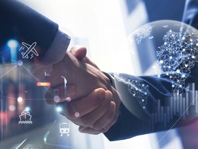 Two business people shaking hands with global trade, shipping, and finance icons overlayed, symbolizing international business.