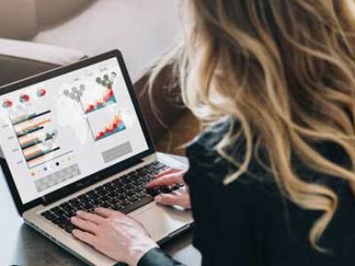 Person examining graphs on a laptop screen