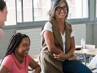 School counselor guiding female high school students during a group session
