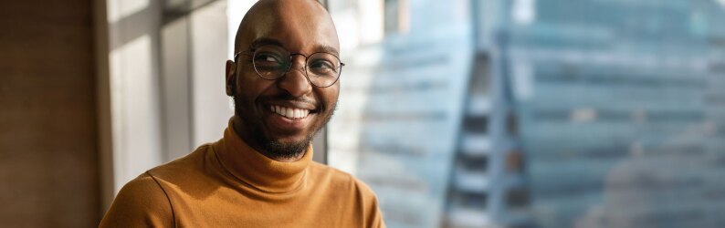 Millennial creative and trendy business entrepreneur smiling and looking away.