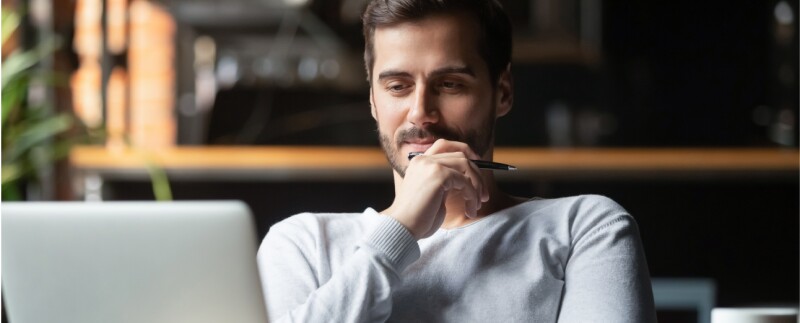 Man focused on reading computer screen