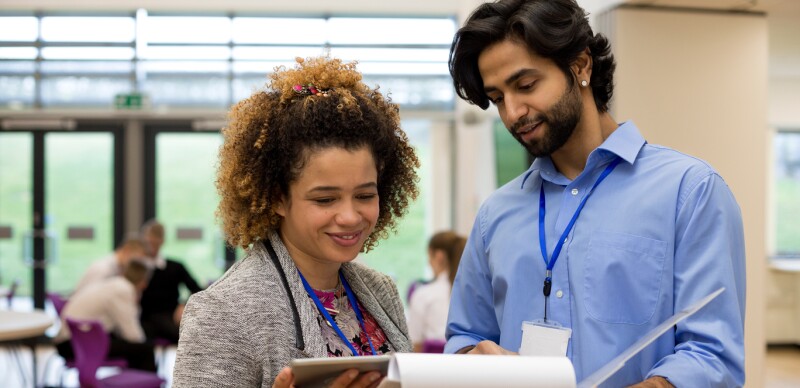 administrator and teacher looking at documents