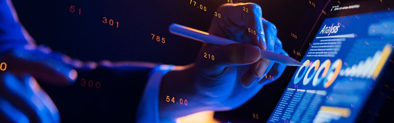 Businessman with financial data on a futuristic stock chart graphic, analytics digital technology.