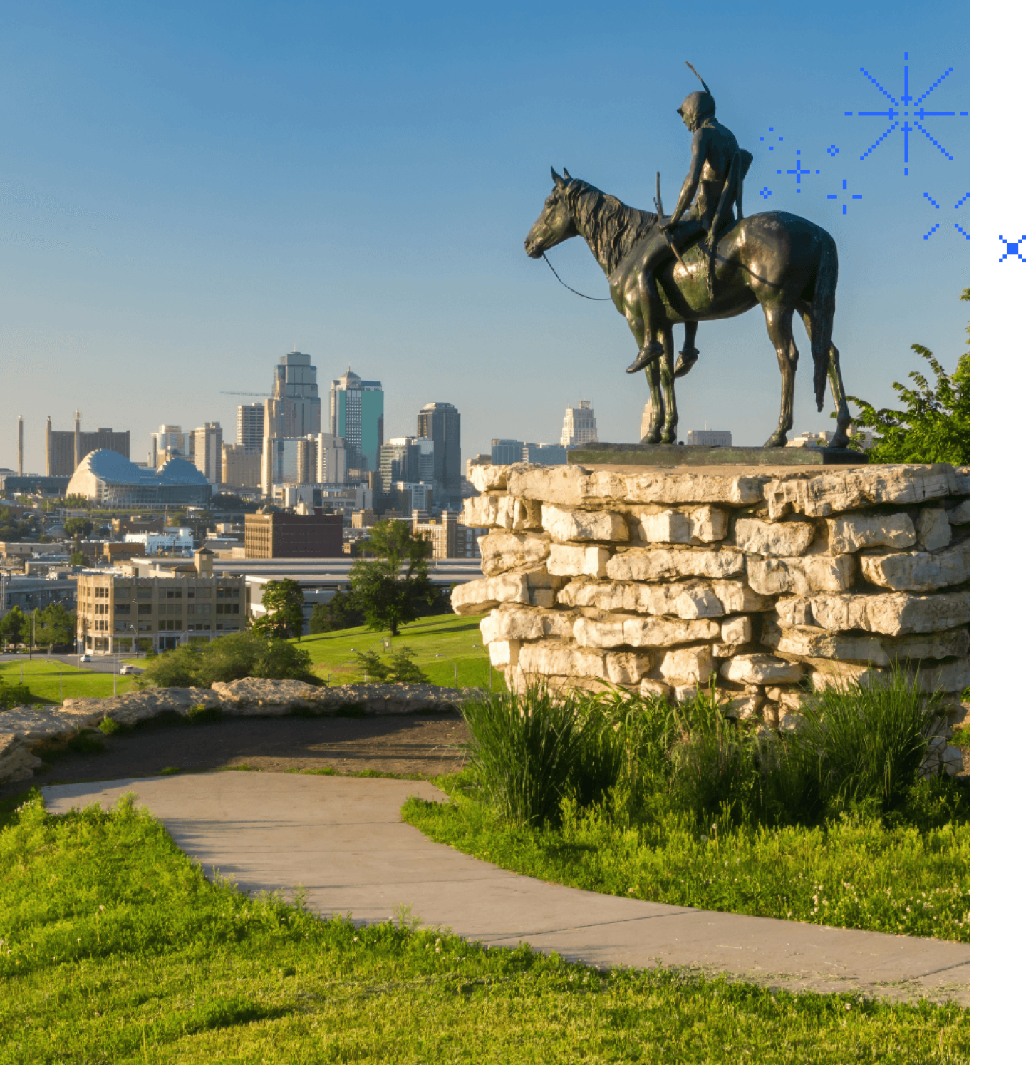 Statue on KU campus of man on horse overlooking downtown area