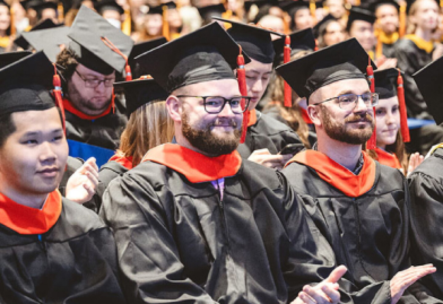 A group shot of CWRU graduates sitting in the graduation ceremony.