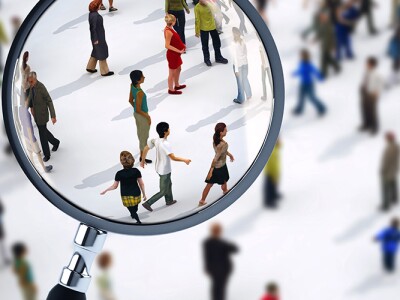 Magnifying glass bringing select people in a crowd into focus