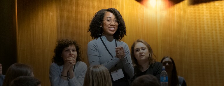 student standing to address a classroom