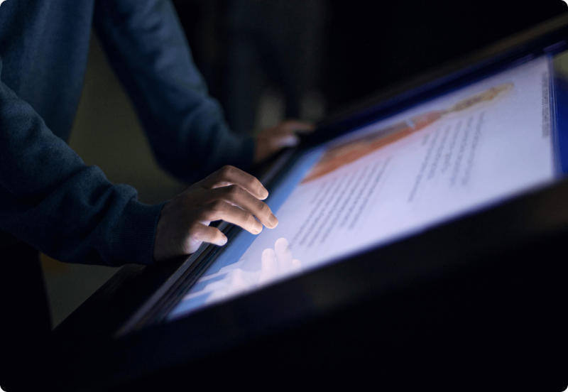 Hands touching an interactive screen