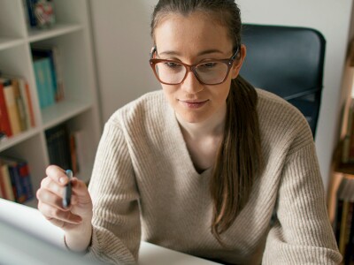 Woman working on computer at her home office