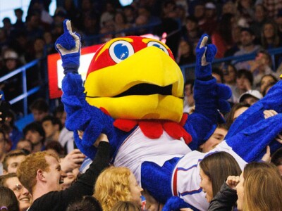 University of Kansas mascot Big Jay crowdsurfing with fans in the Allen Fieldhouse during a basketball game