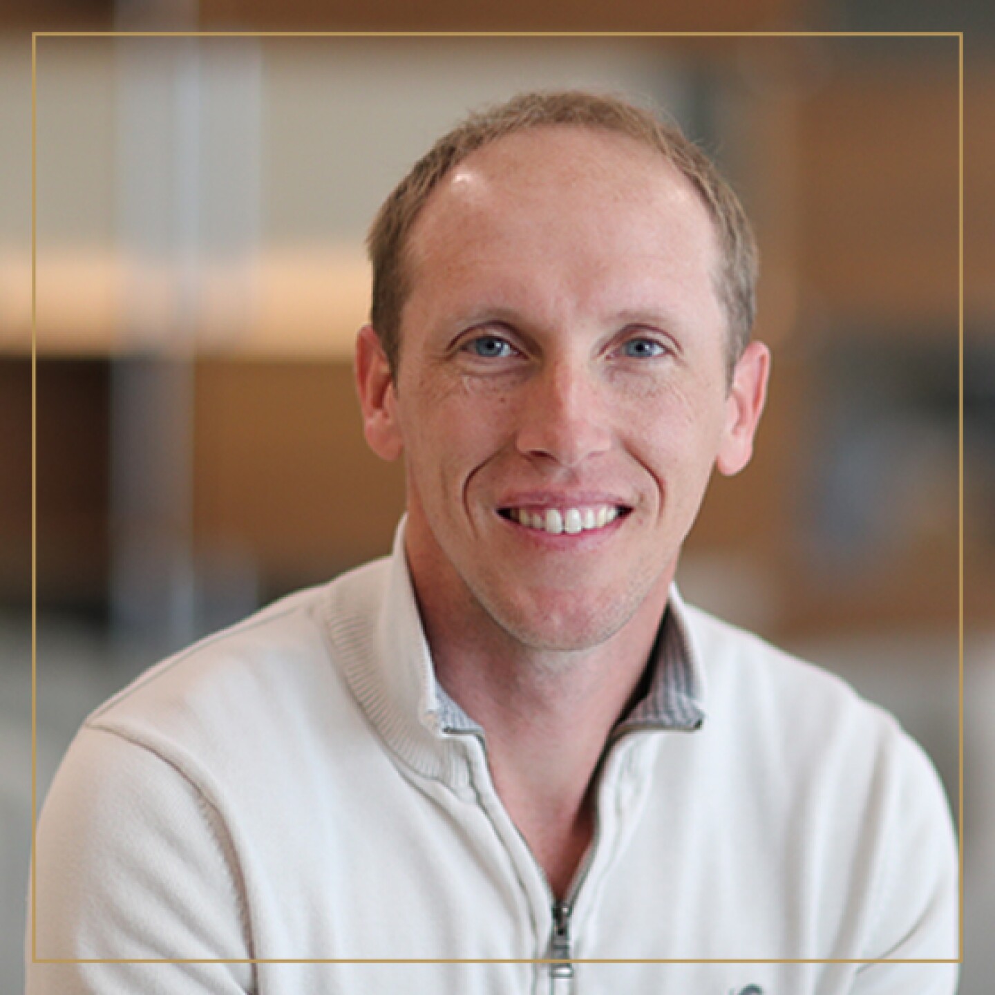 Man smiling in white collared shirt