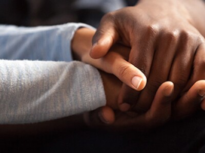 Two individuals holding hands